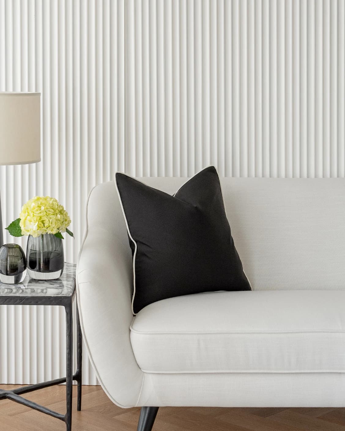 Aelia Steele cushion in black, shown in a lifestyle front view as image 4