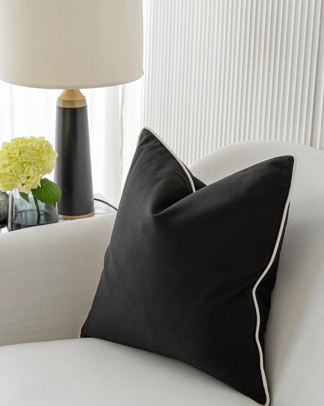 Aelia Steele cushions in black, shown in a lifestyle right view as video image