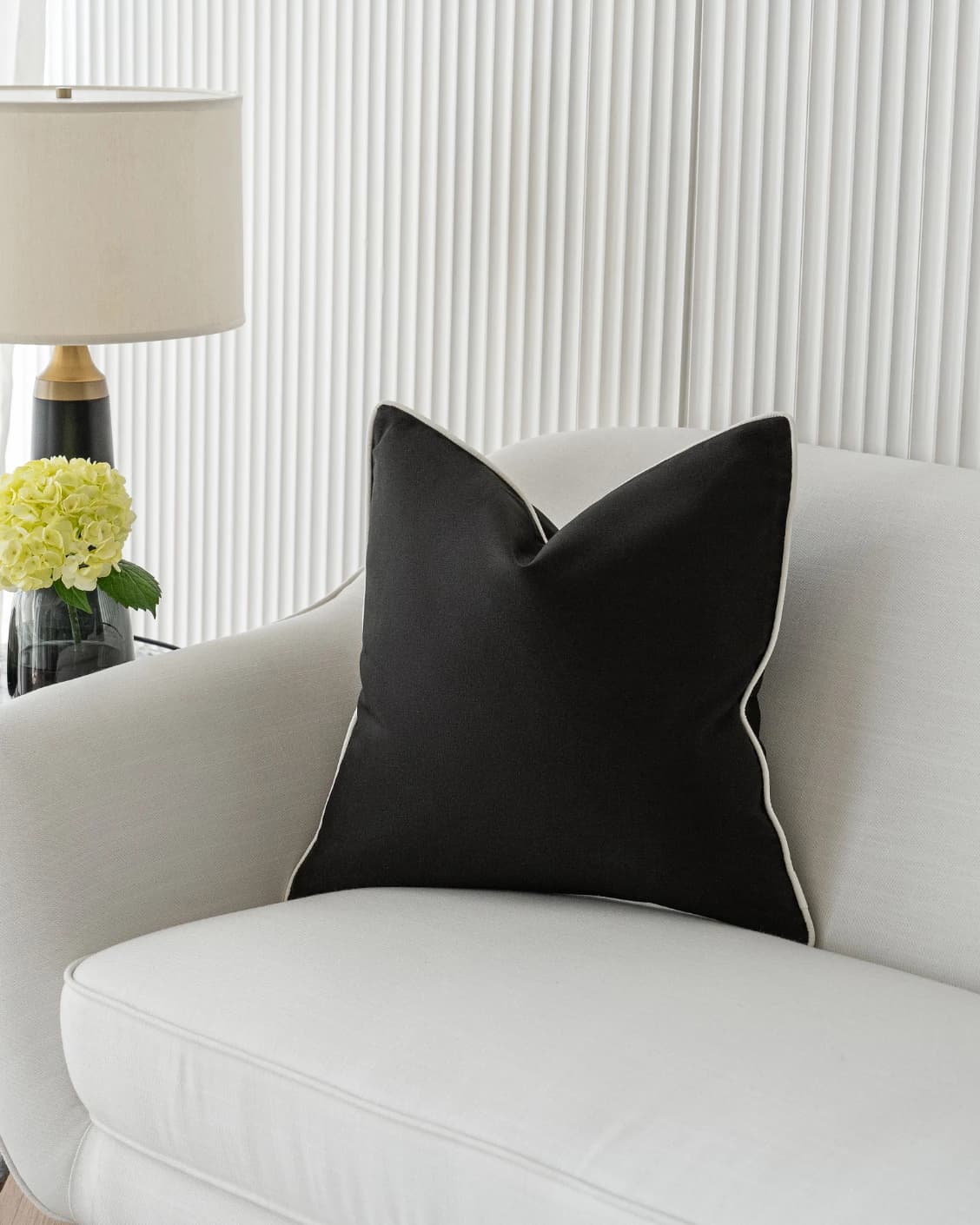 Aelia Steele cushion in black, shown in a lifestyle right view as image 2