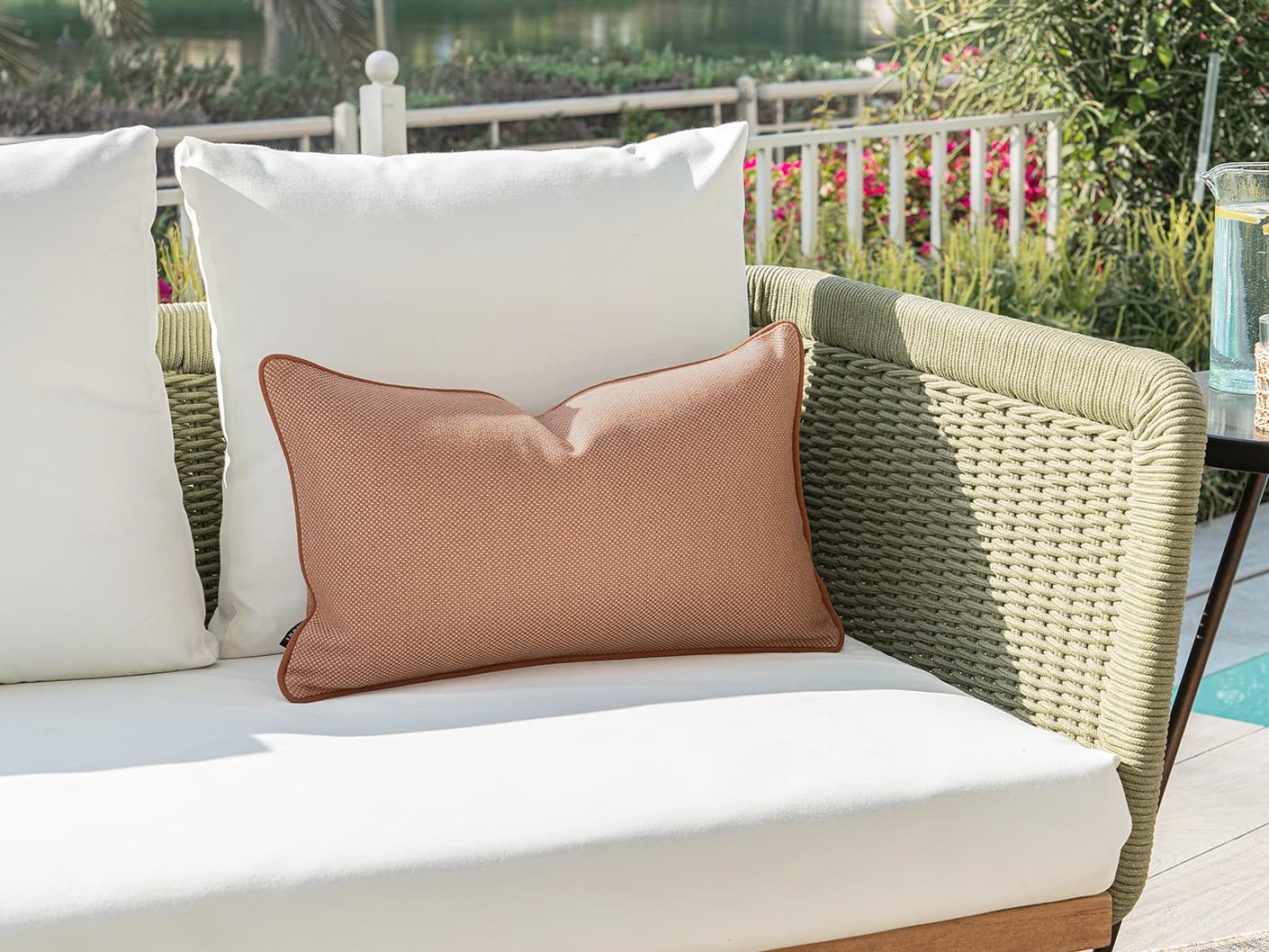 Aelia Tangelo II single cushions in tangelo and rust, shown in a lifestyle left view
