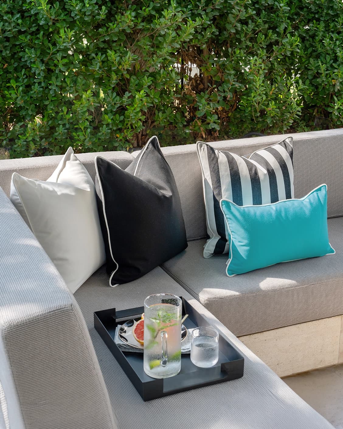 Aelius Bundle cushion in ivory, turquoise and black, shown in a lifestyle left view as image 2