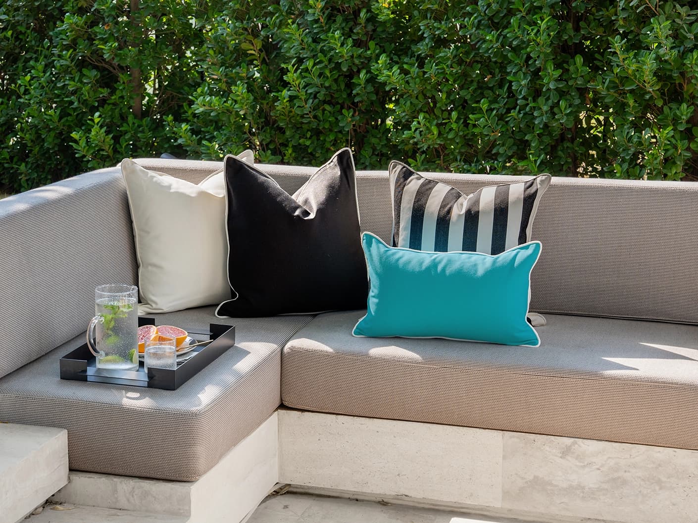 Aelius Bundle bundle cushions in ivory, turquoise and black, shown in a lifestyle front view