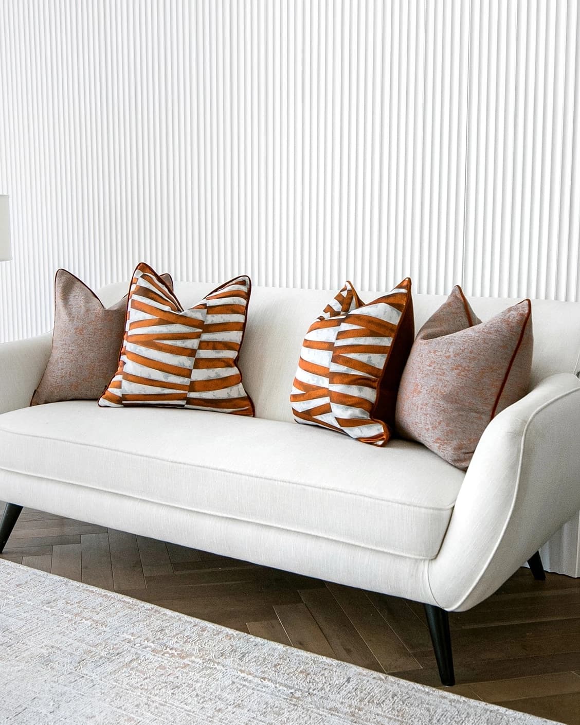 Alani Bundle cushion in orange, white and red, shown in a lifestyle right view as image 2