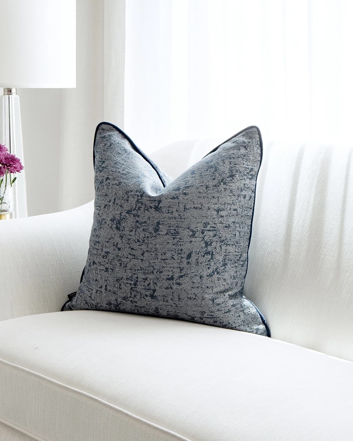 Alba Canova cushion in navy, grey and blue, shown in a lifestyle left view as image 2