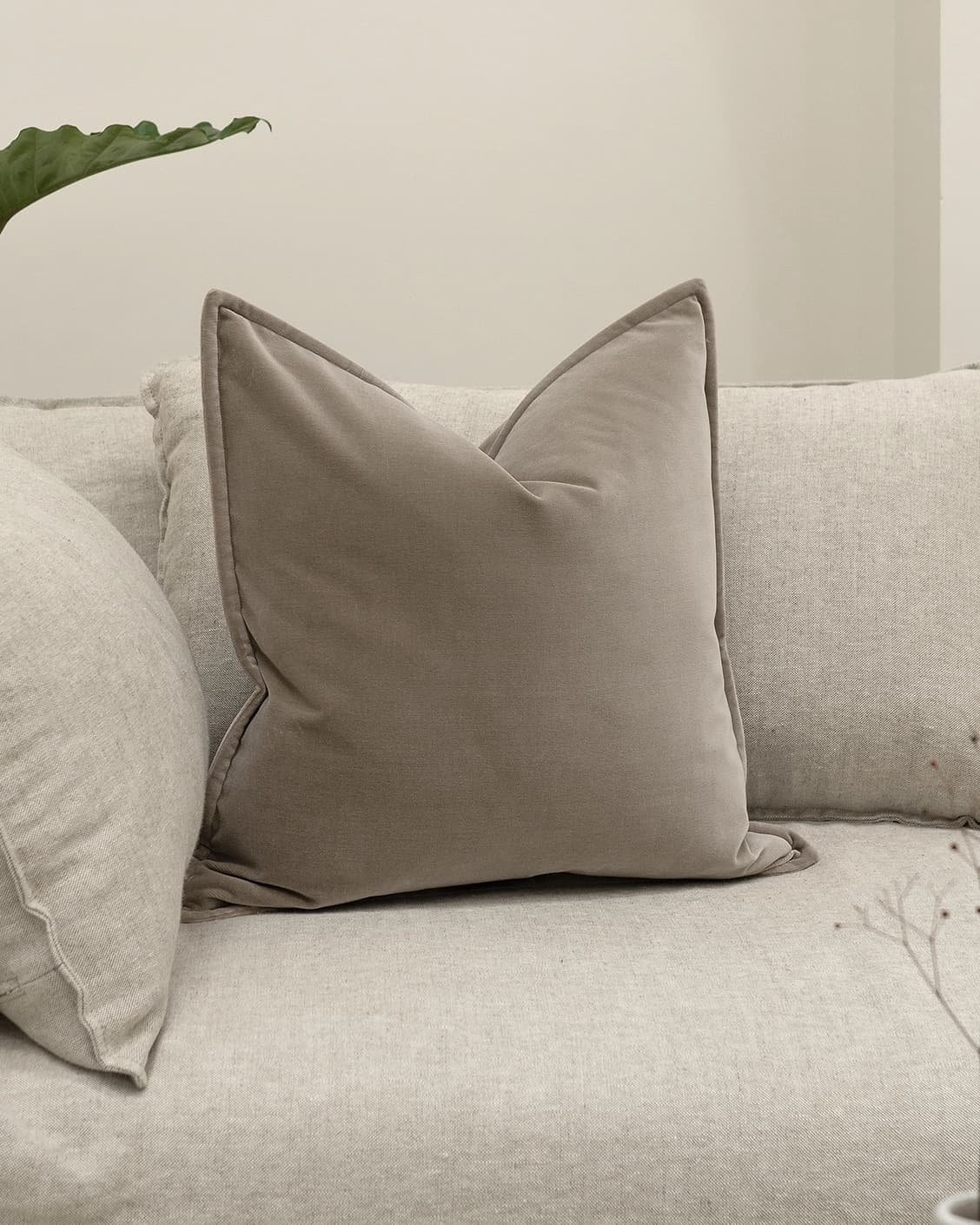 Alessandra Alpaca cushion in brown, shown in a lifestyle front view as image 2