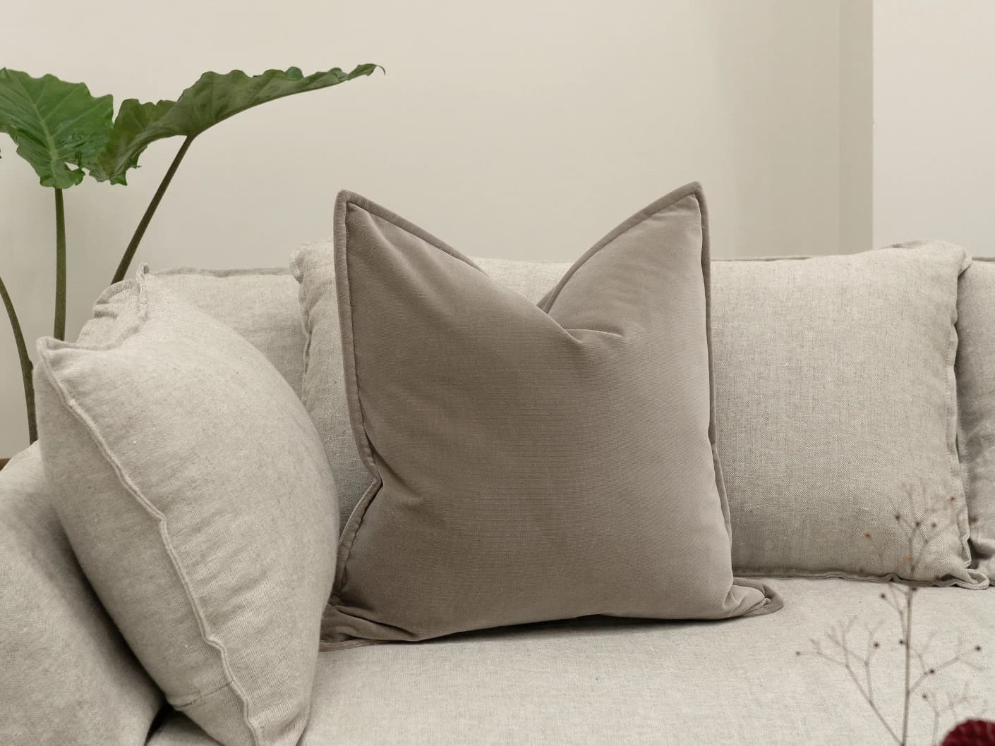 Alessandra Alpaca single cushions in brown, shown in a lifestyle front view