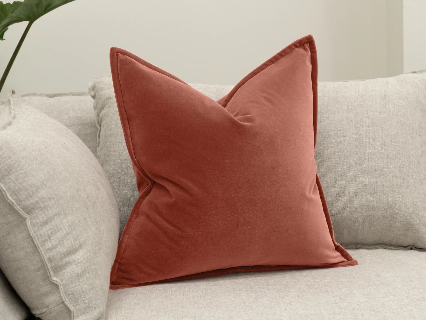 Alessandra Blush single cushions in pink and red, shown in a lifestyle left view