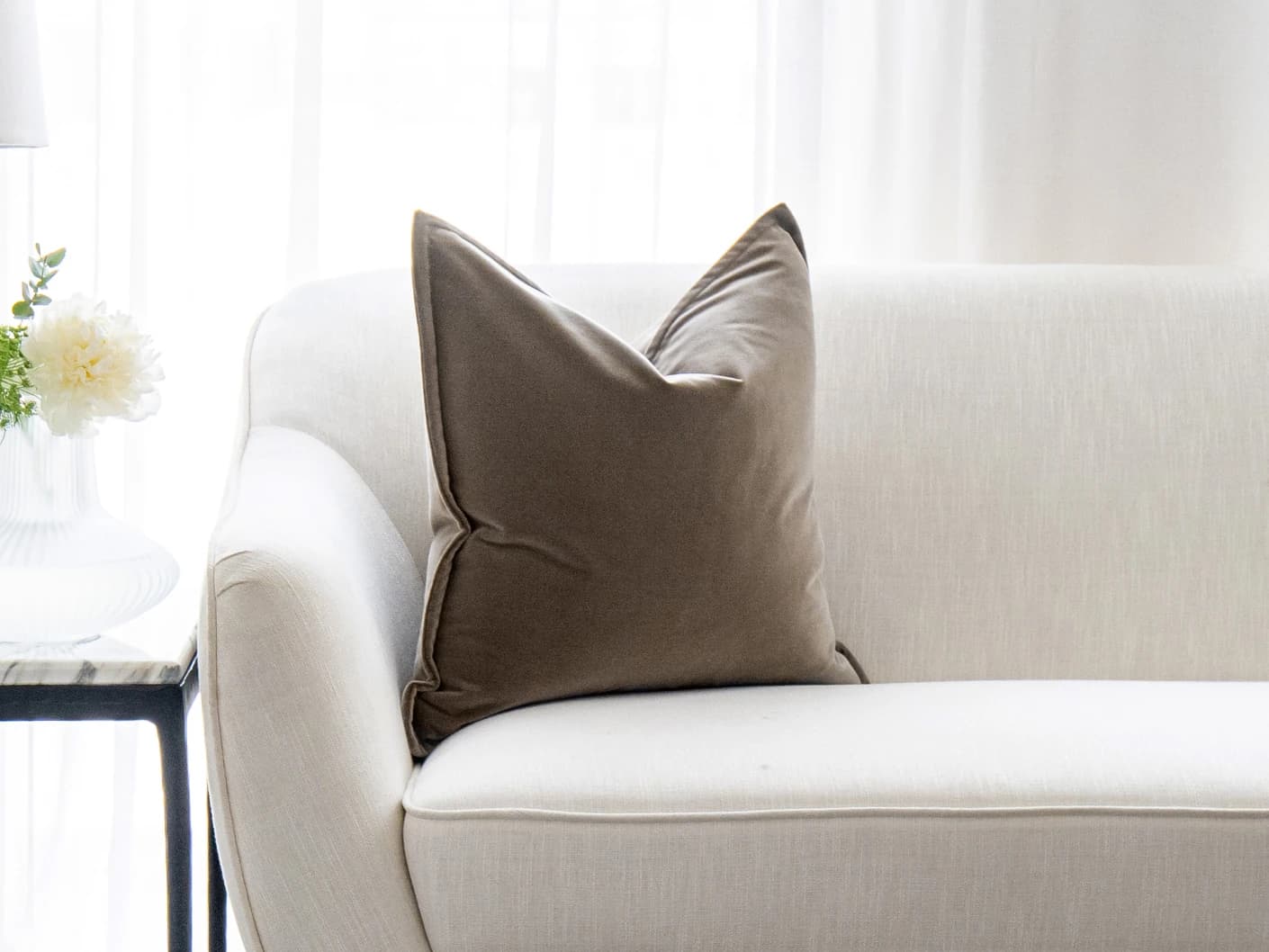 Alessandra Braun single cushions in brown, shown in a lifestyle front view