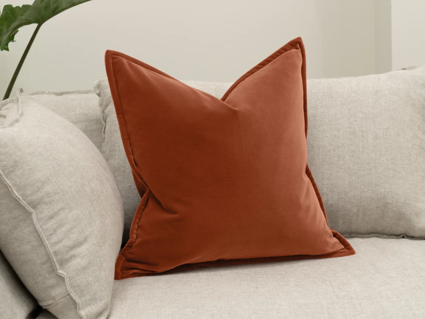 Alessandra Crimson single cushions in orange, shown in a lifestyle front view