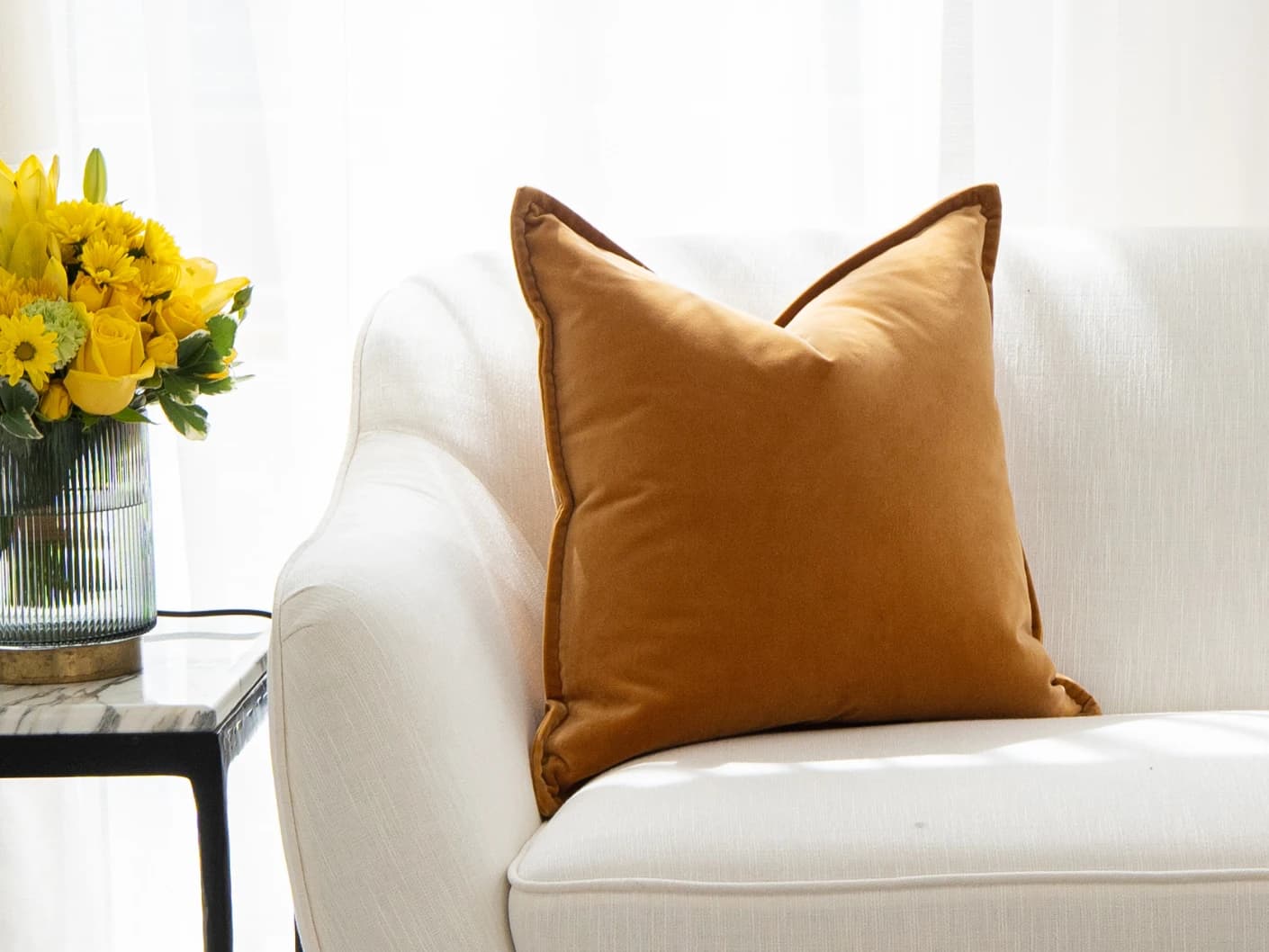 Alessandra Hodler single cushions in orange, shown in a lifestyle front view
