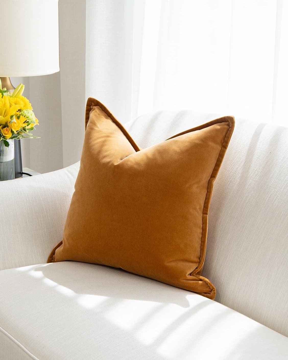 Alessandra Hodler cushion in orange, shown in a lifestyle top view as image 2