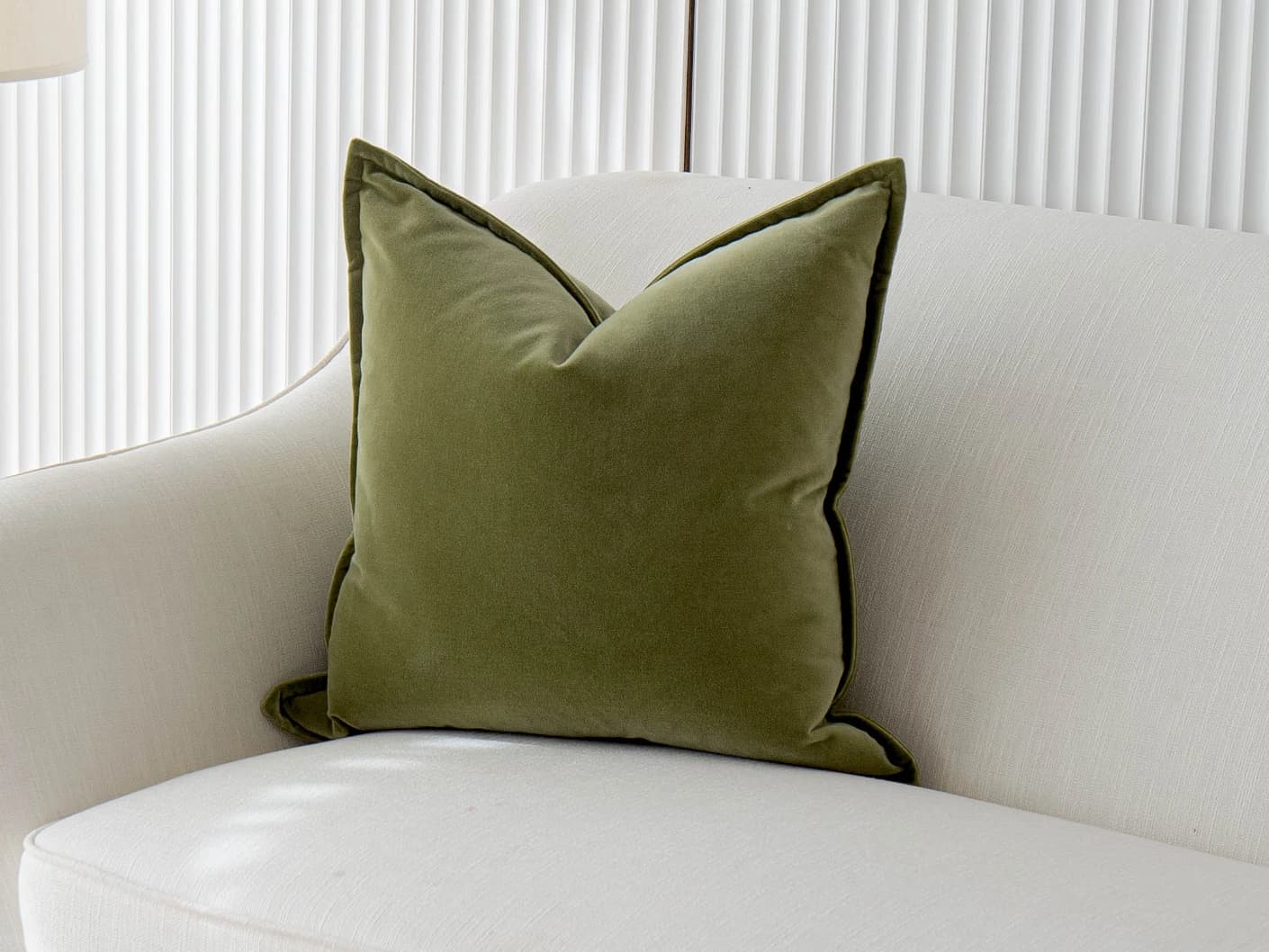 Alessandra Jade single cushions in green, shown in a lifestyle front view