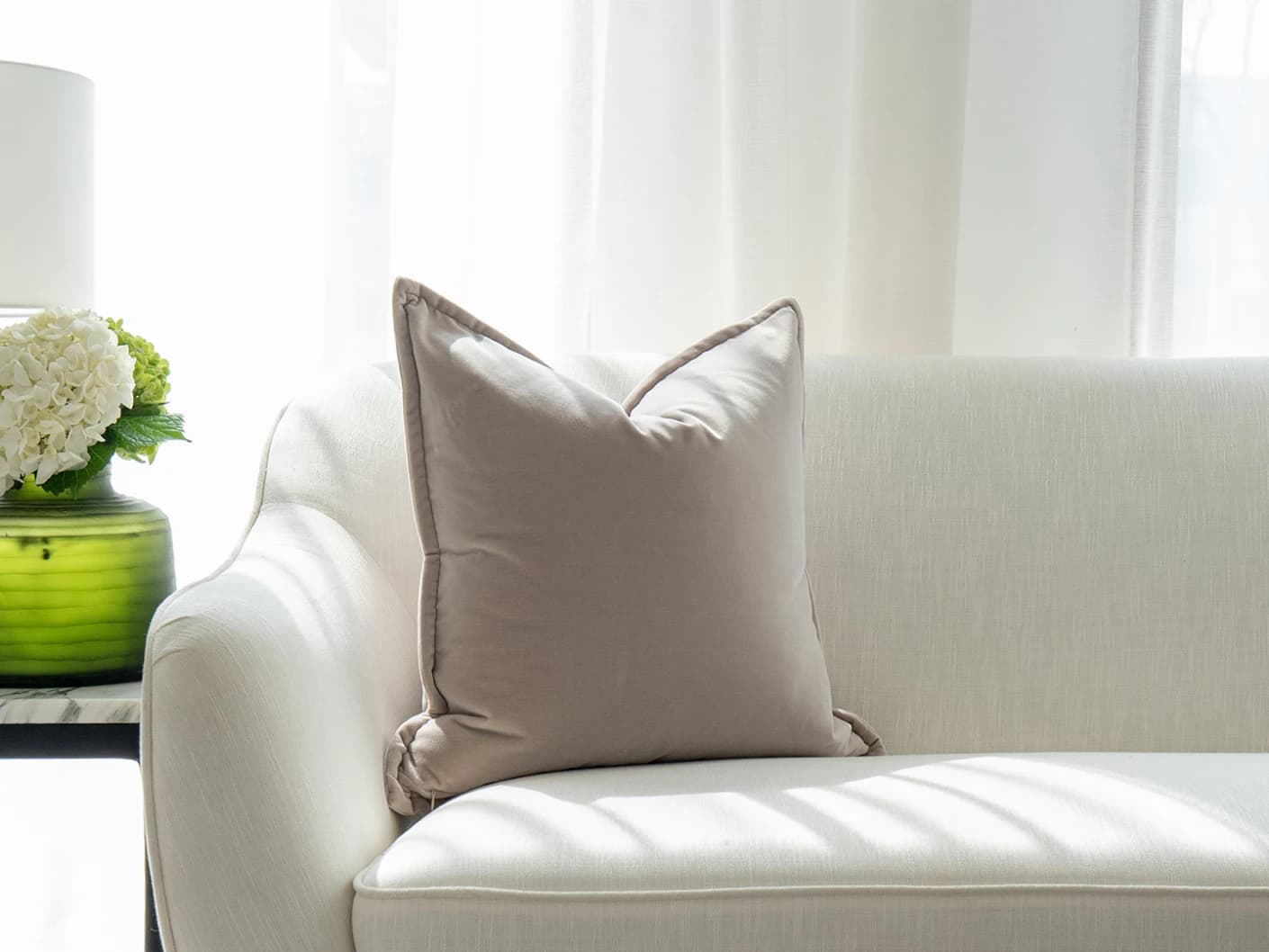 Alessandra Klimt single cushions in beige, shown in a lifestyle front view