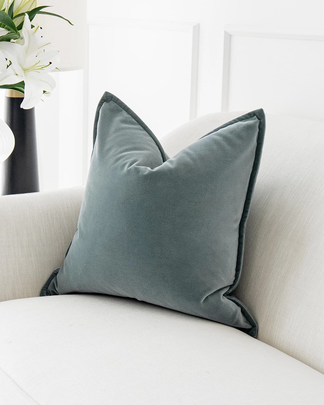 Alessandra Lucas cushion in pastel blue and blue, shown in a lifestyle front view as image 2