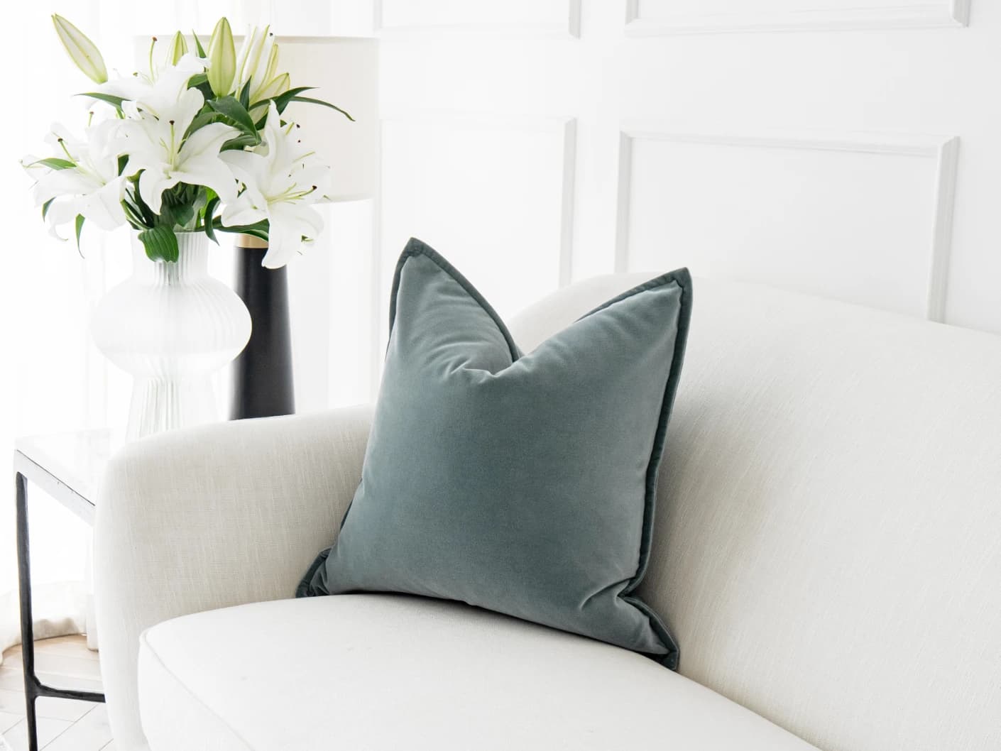 Alessandra Lucas single cushions in pastel blue and blue, shown in a lifestyle front view