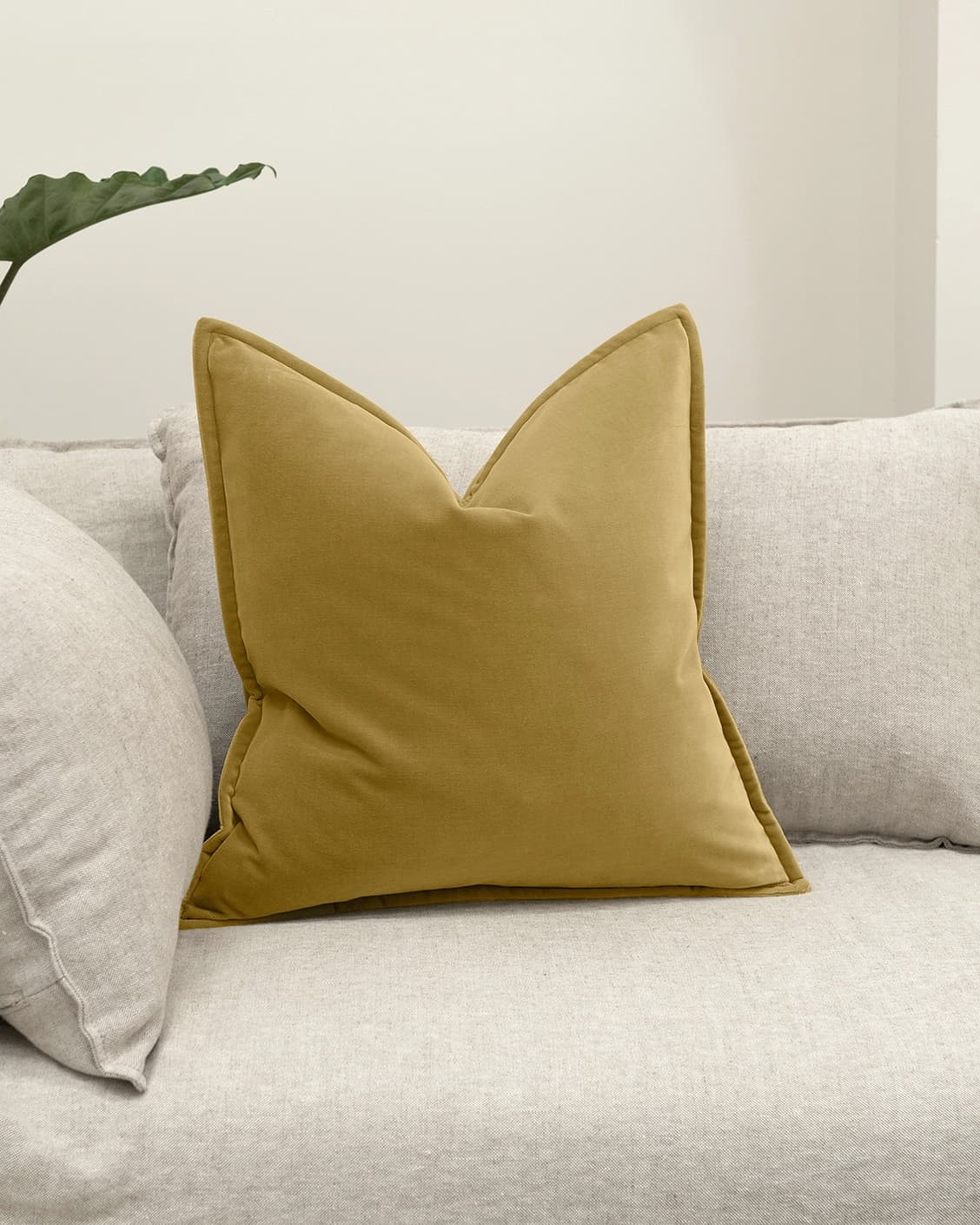 Alessandra Moss cushion in gold, shown in a lifestyle front view as image 2