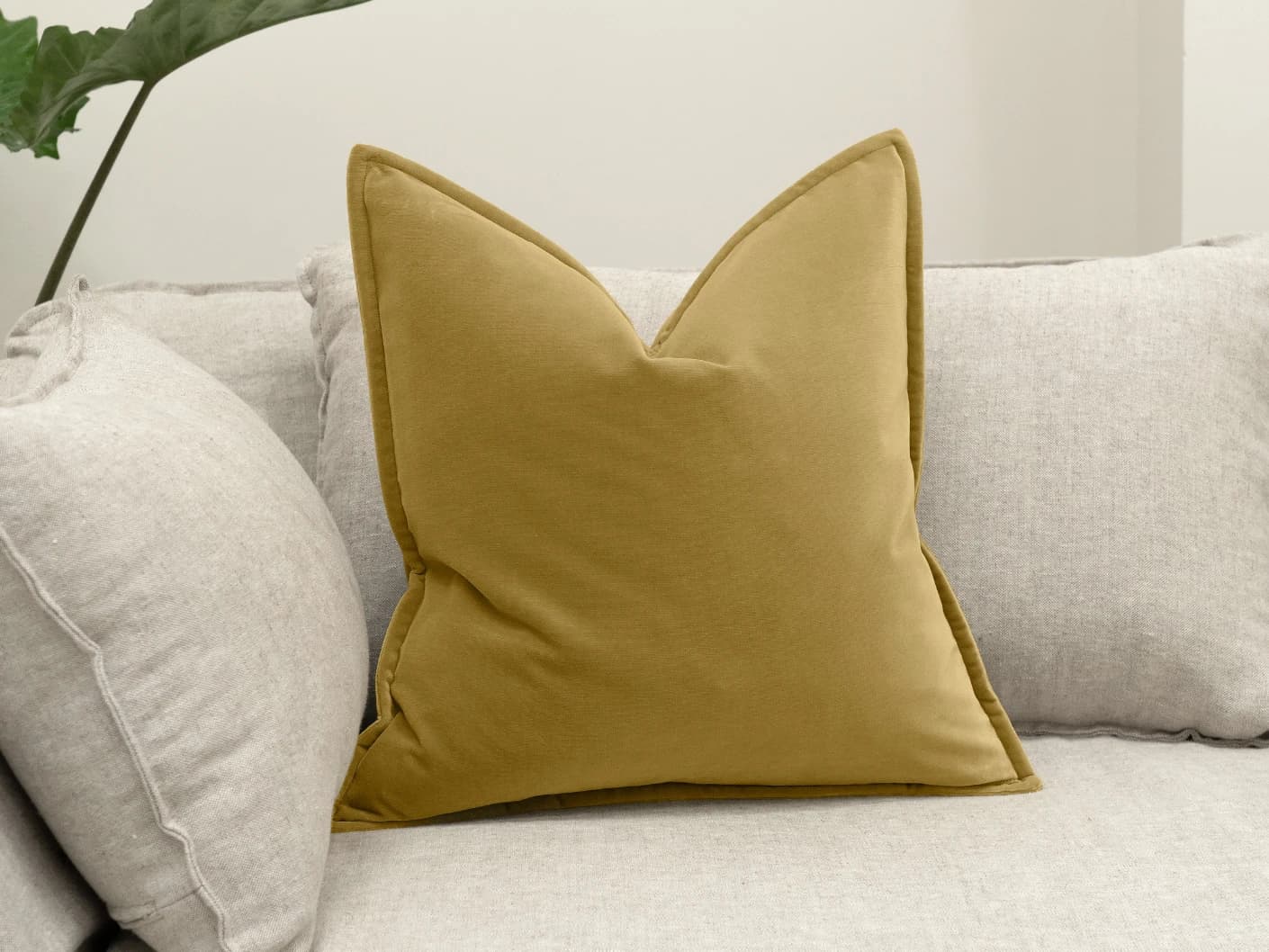 Alessandra Moss single cushions in gold, shown in a lifestyle front view