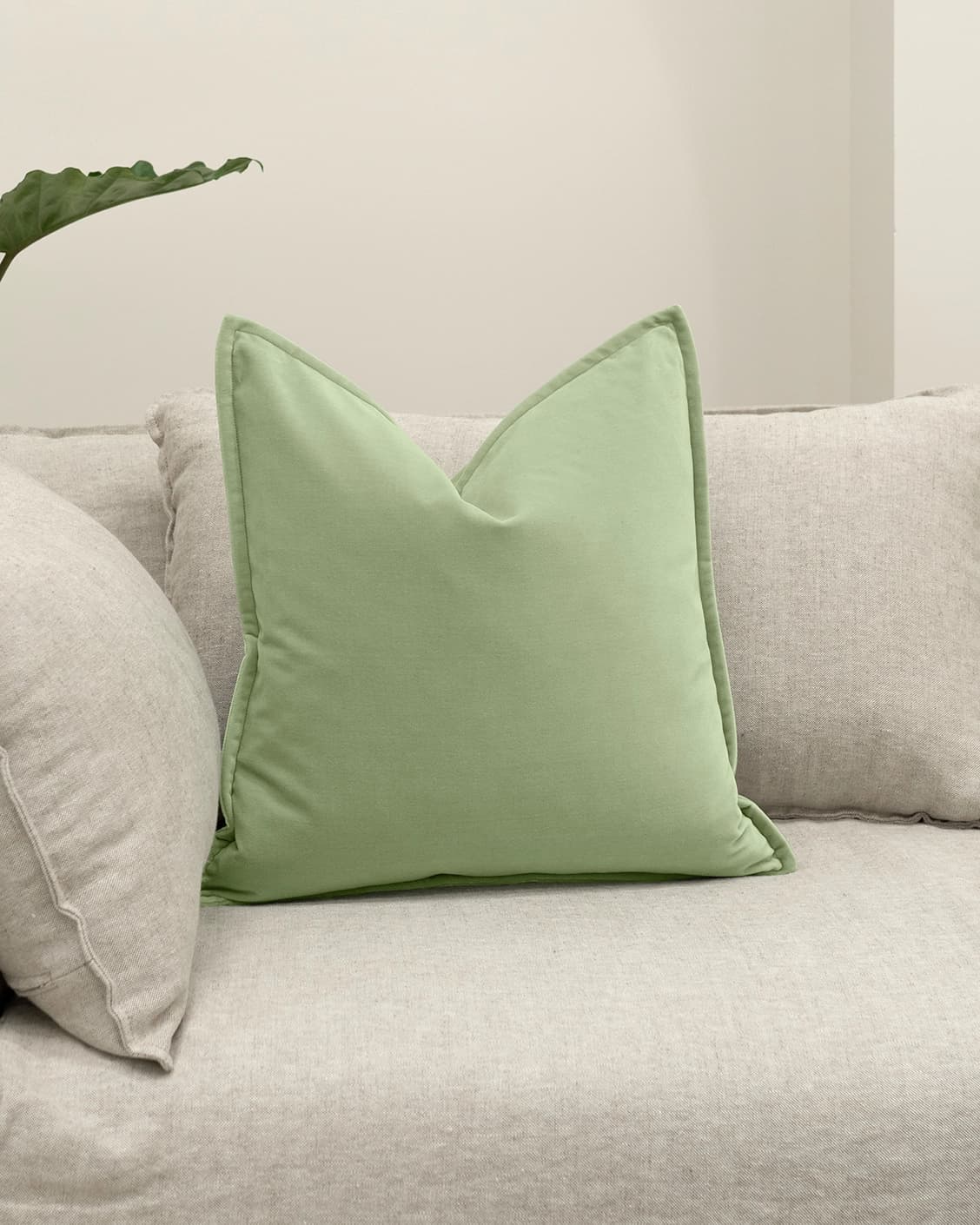 Alessandra Pistachio cushion in green, shown in a lifestyle front view as image 2
