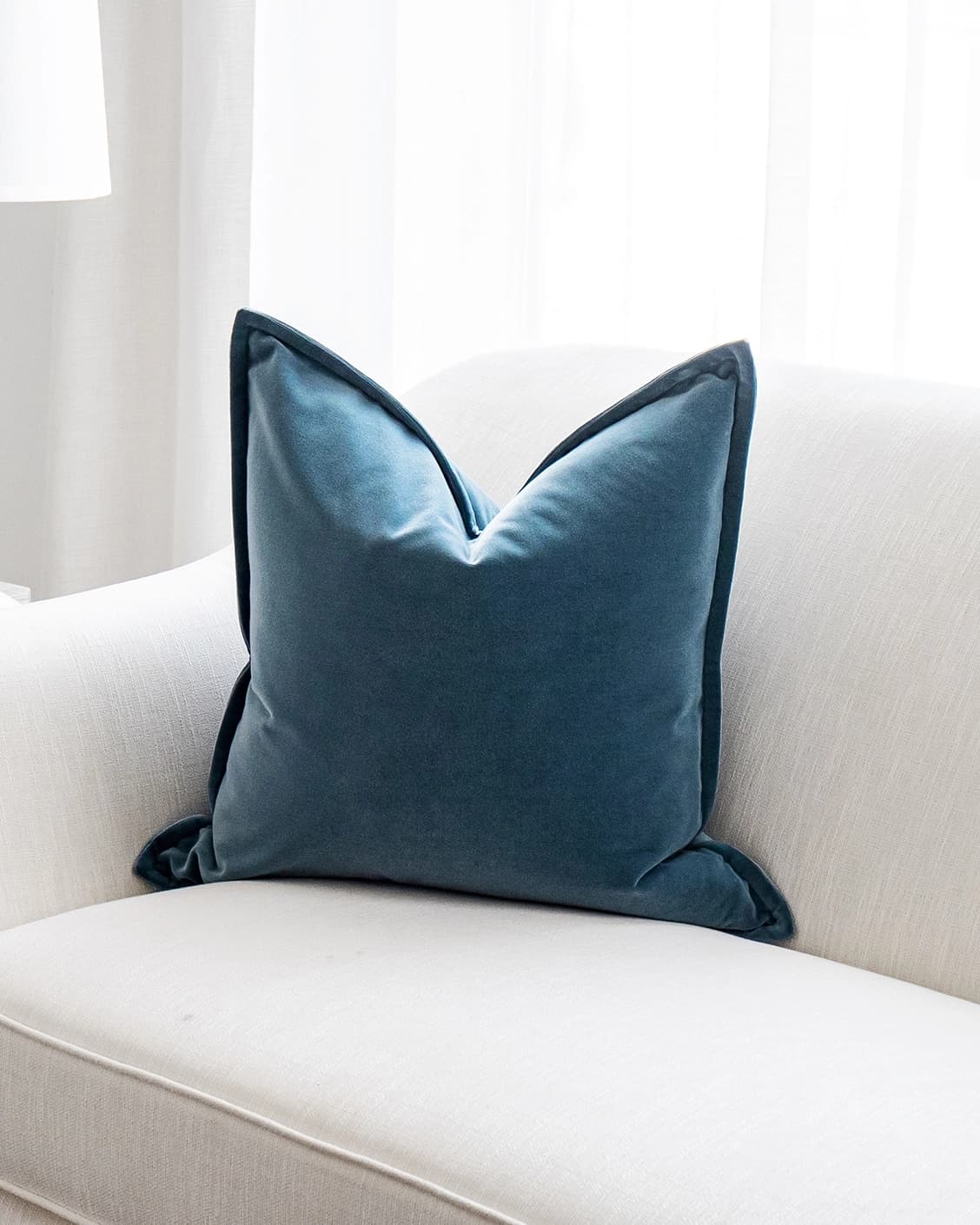 Alessandra Sky cushion in blue, shown in a lifestyle front view as image 2