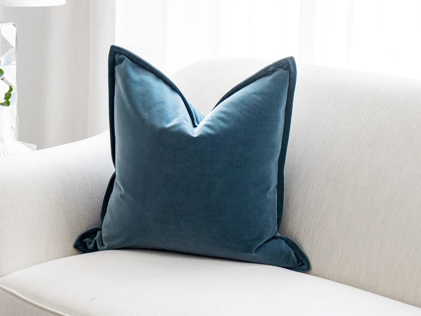 Alessandra Sky single cushions in sky and blue, shown in a lifestyle front view