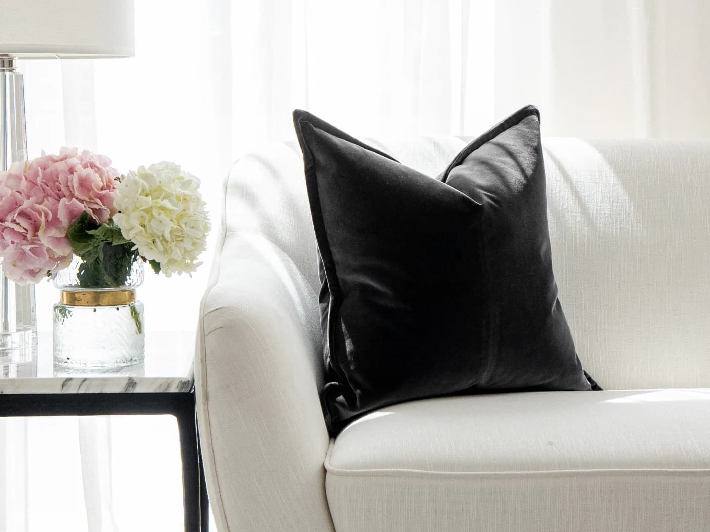 Alessandra Steele single cushions in charcoal and grey, shown in a lifestyle front view
