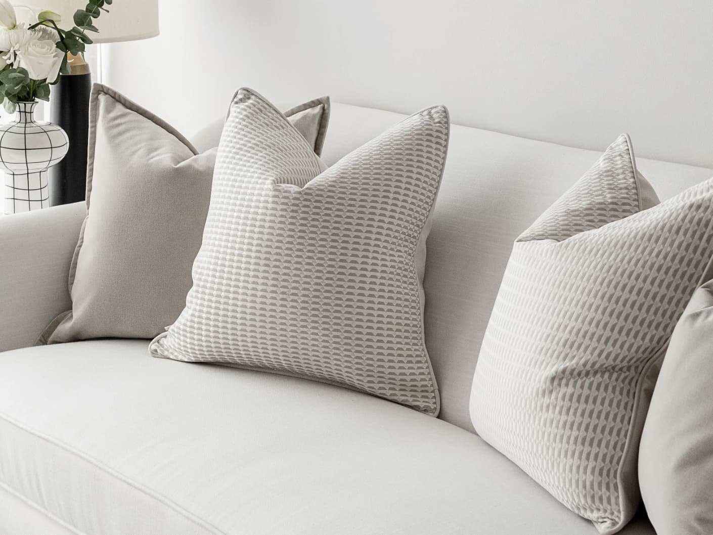Alex Bundle bundle cushions in beige and white, shown in a lifestyle front view