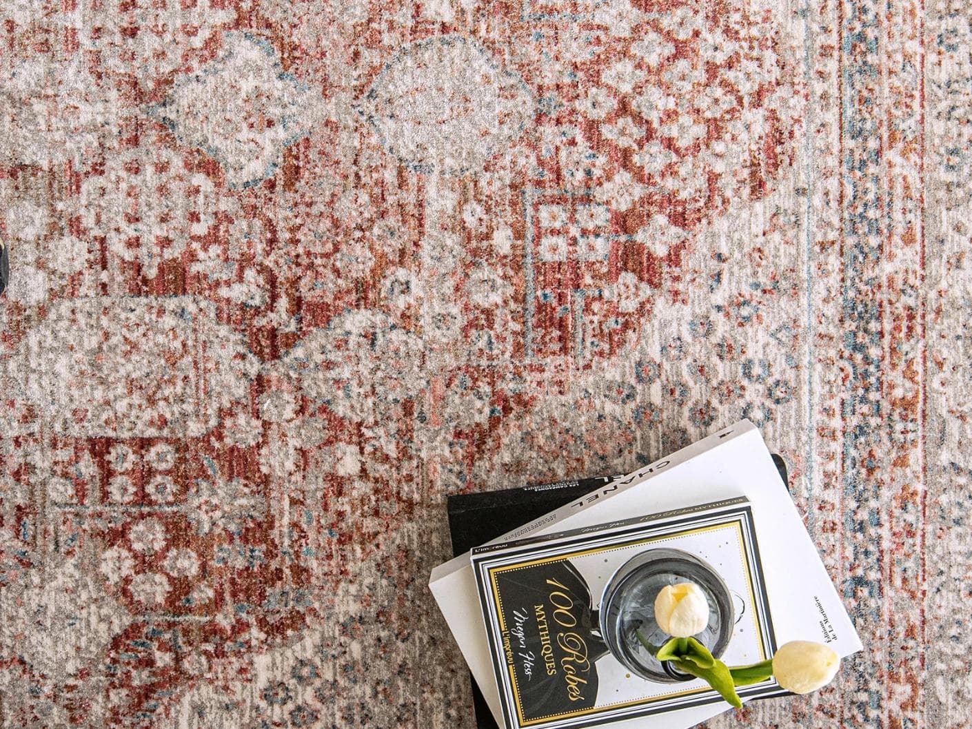 Alexander Rosso carpet in red and beige, shown in a lifestyle close-up top view as image 4