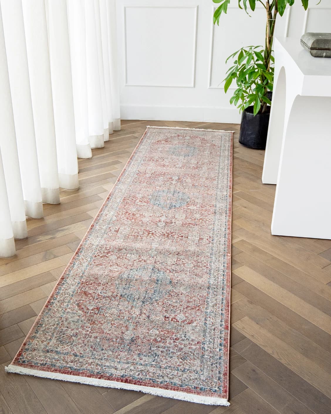 Alexander Rosso carpet in red and beige, shown in a lifestyle left view as image 7