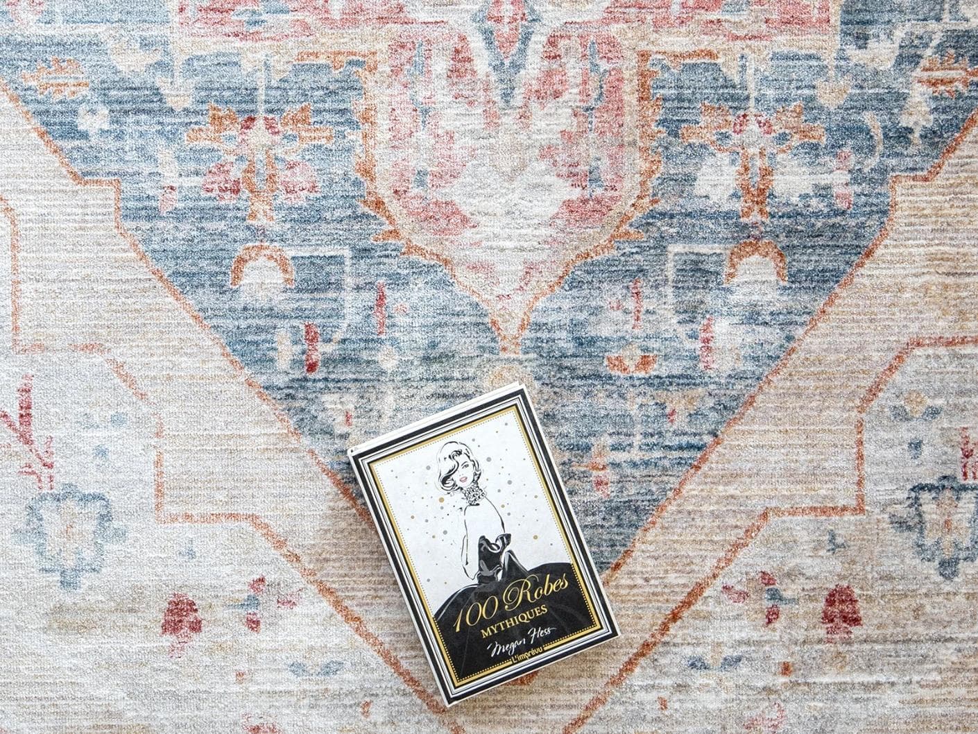 Alexander Rouge carpets in beige, blue and red, shown in a lifestyle close-up top view as image 3
