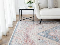 Alexander Rouge carpet in beige, blue and red, shown in a lifestyle front view