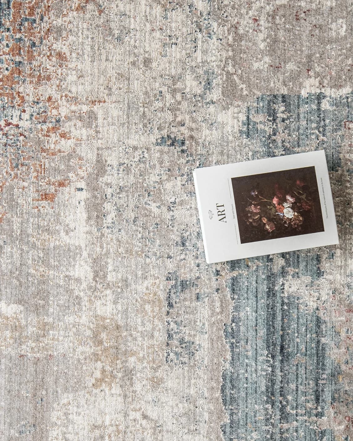 Alexander Russell carpet in beige, rust and blue, shown in a lifestyle close-up as image 4