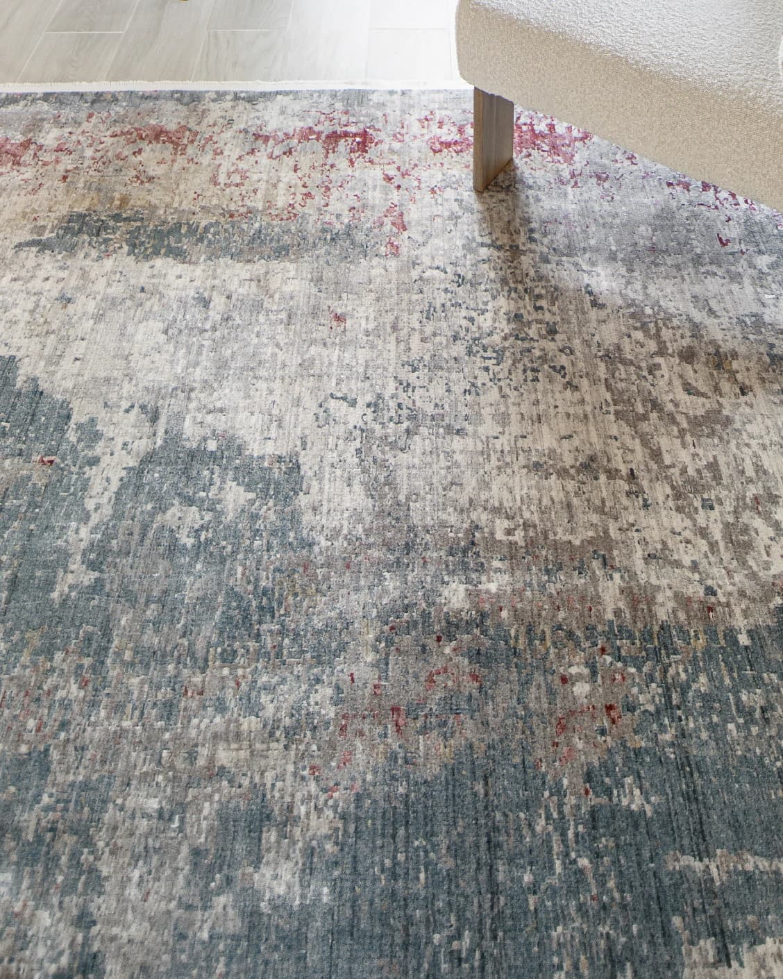 Alexander Russell carpet in beige, rust and blue, shown in a lifestyle close-up top view as image 5