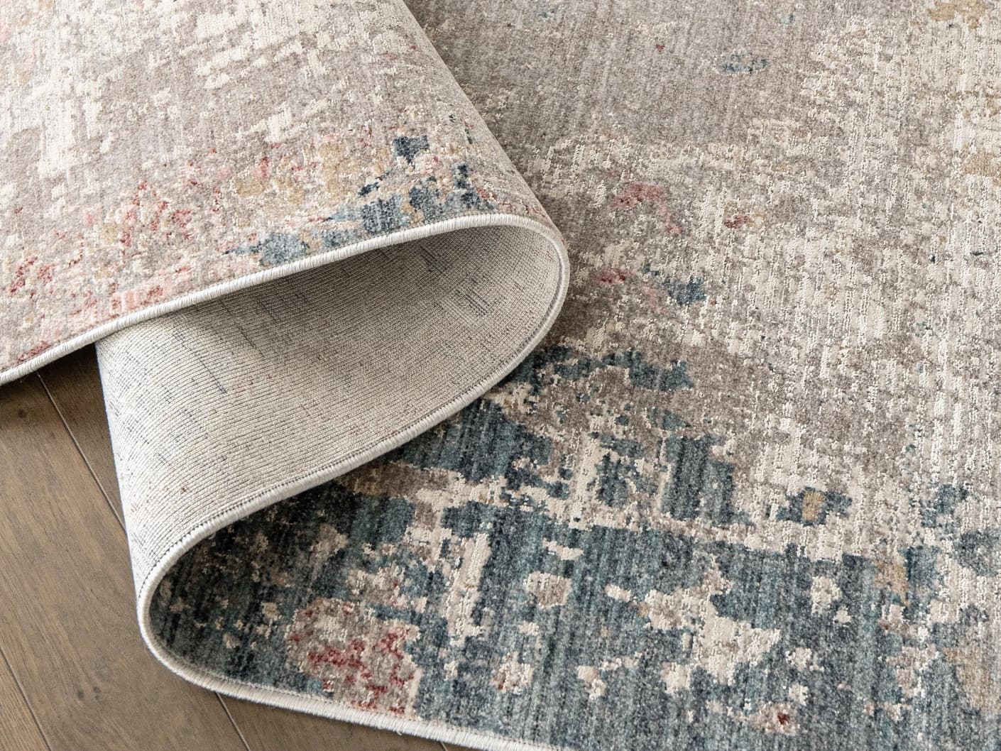 Alexander Russell carpets in beige, rust and blue, shown in a product close-up top view