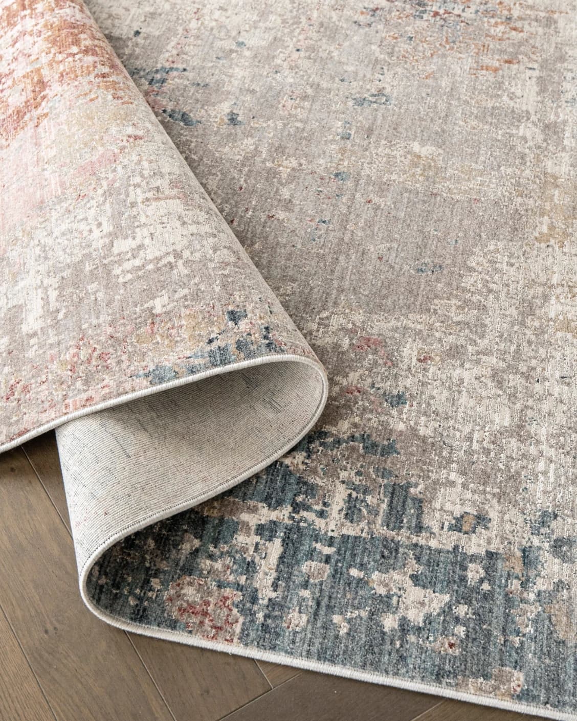 Alexander Russell carpet in beige, rust and blue, shown in a product close-up top view as image 11