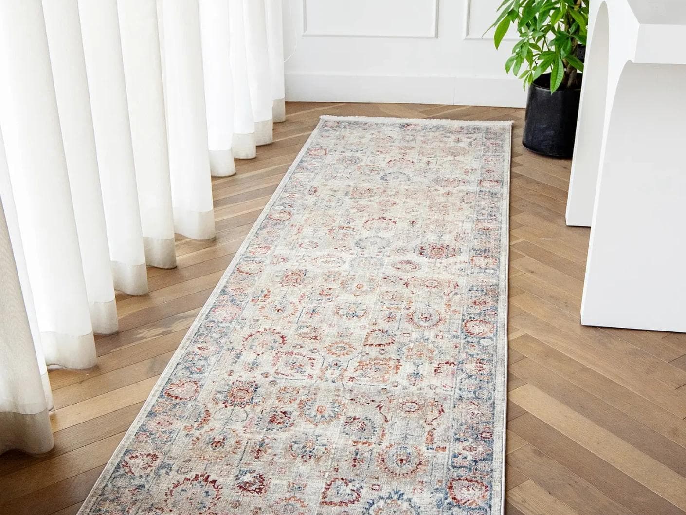 Alexander Sandy carpets in beige and red, shown in a lifestyle right view as image 1