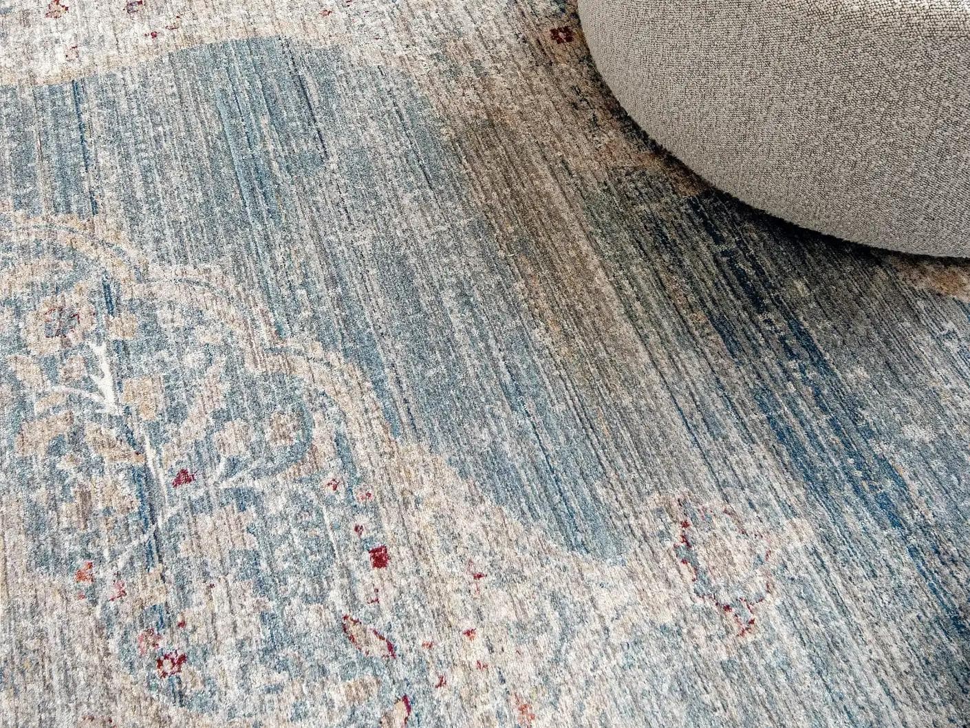 Alexander Sky carpet in pale blue, blue and beige, shown in a lifestyle close-up as image 5