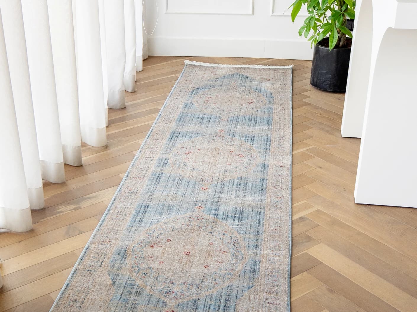 Alexander Sky Runners carpet in pale blue, blue and beige, shown in a product front view