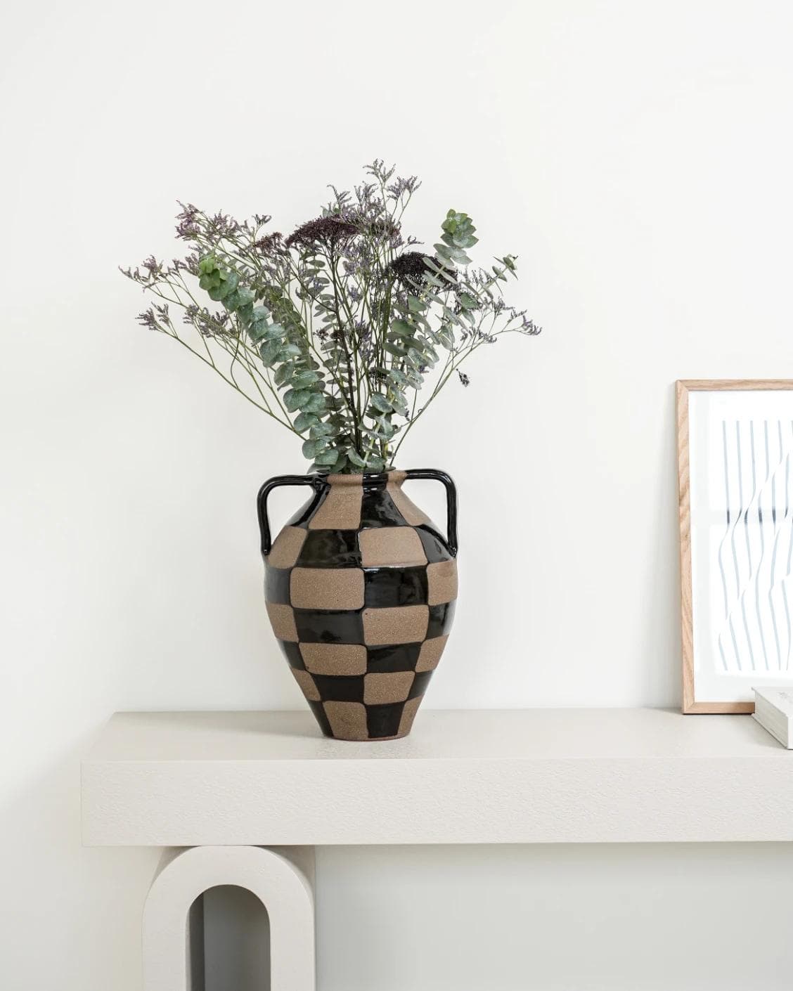 Alisca Terra vases in charcoal black, warm clay, brown and black, shown in a lifestyle front view as image 2