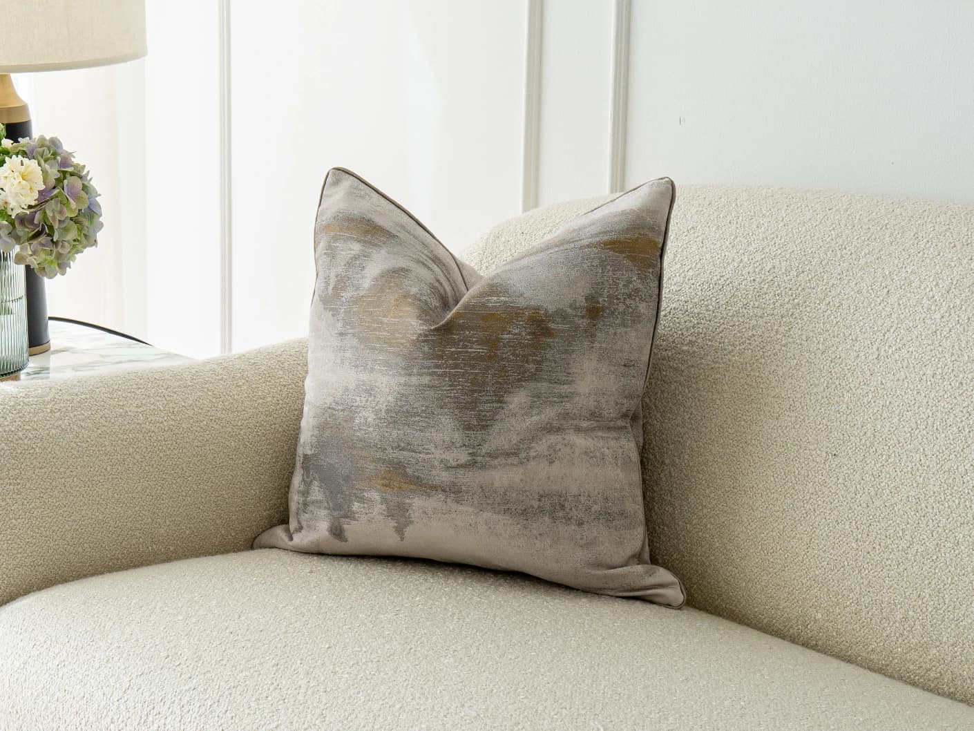 Alma Klimt single cushions in yellow and silver, shown in a lifestyle front view