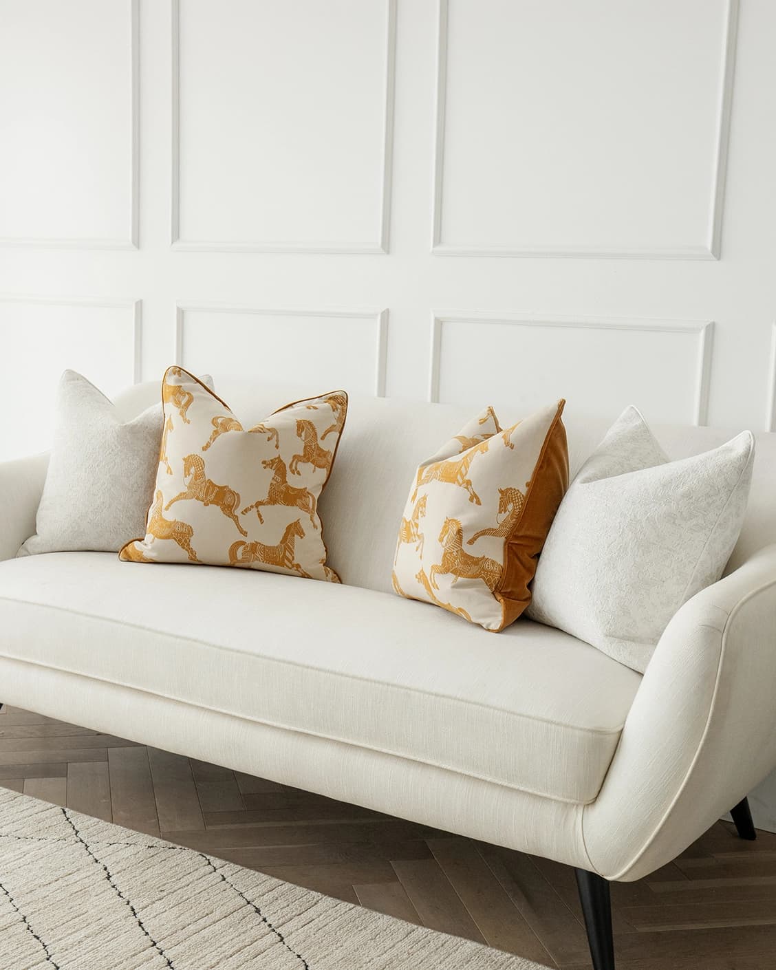Alona Bundle cushion in white, orange and beige, shown in a lifestyle front view as image 2