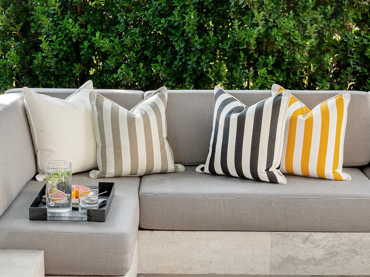 Altan Bundle cushion in soft ivory, black, yellow and beige, shown in a lifestyle front view as image 2