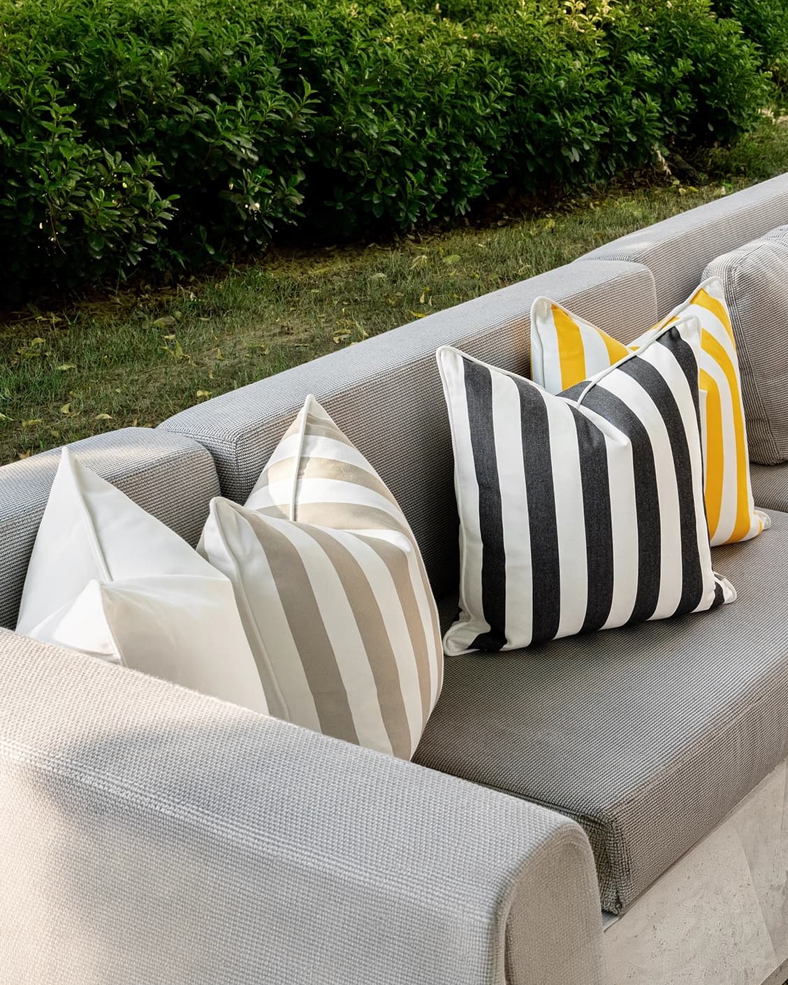 Altan Bundle cushion in soft ivory, black, yellow and beige, shown in a lifestyle front view as image 4