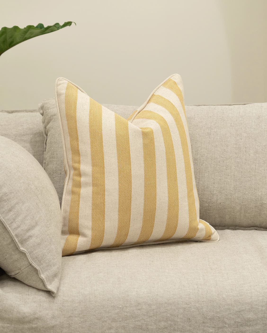 Ameline Barrymore cushion in yellow, shown in a lifestyle left view as image 2