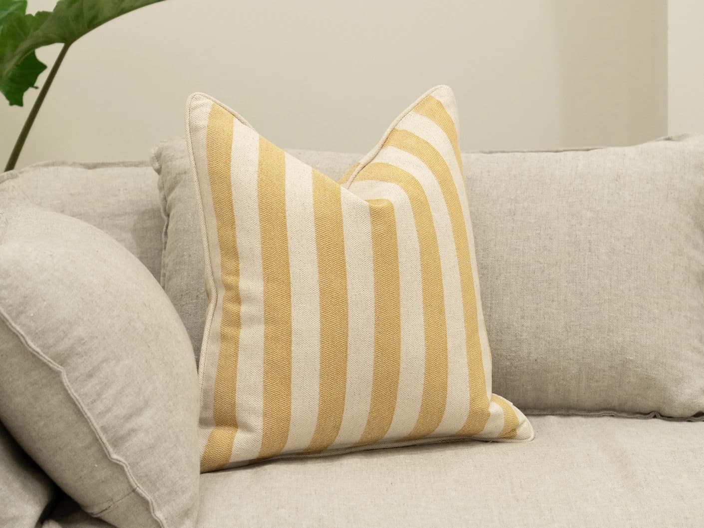 Ameline Barrymore single cushions in yellow, shown in a lifestyle left view