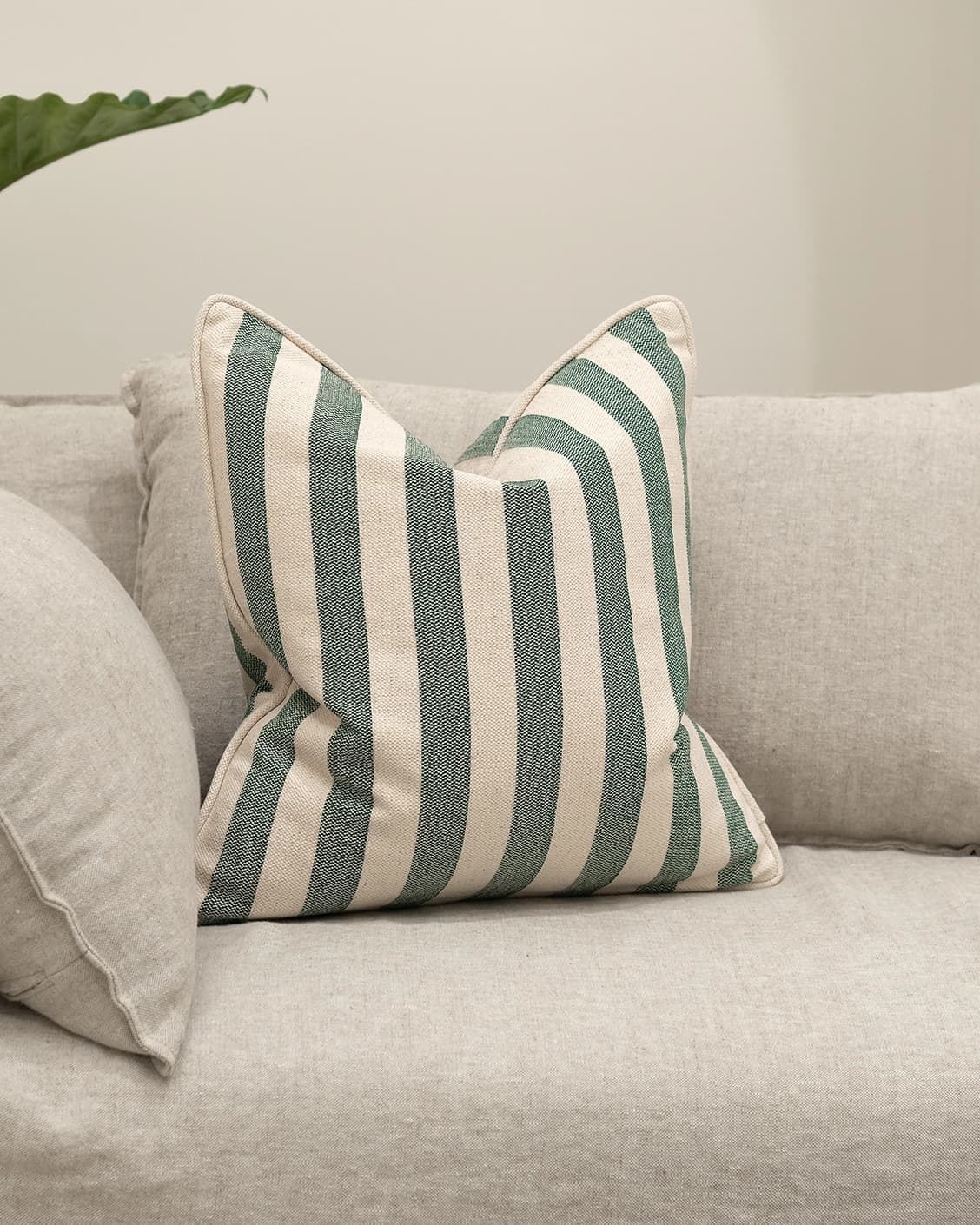 Ameline Forest cushion in forest green, shown in a lifestyle front view as image 2