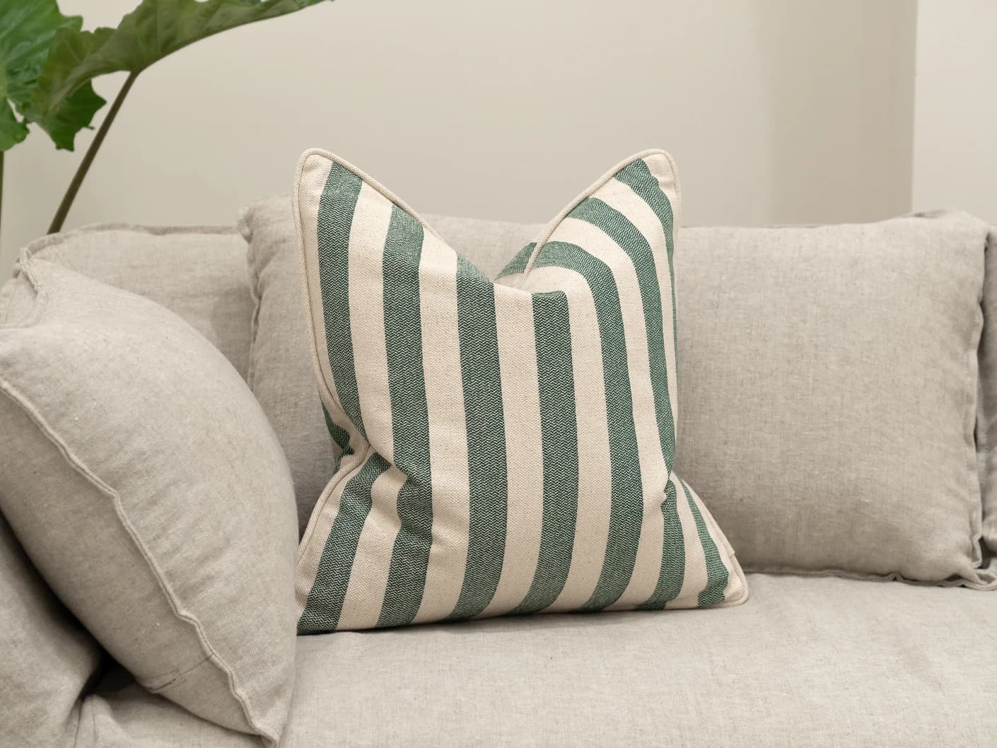 Ameline Forest single cushions in forest green, shown in a lifestyle front view