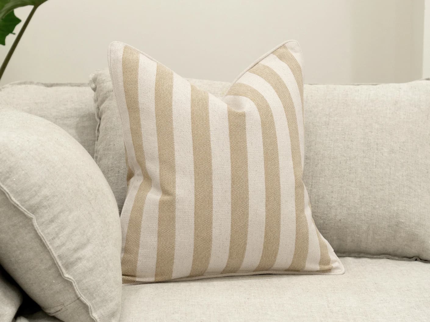 Ameline Klimt single cushions in beige, shown in a lifestyle front view