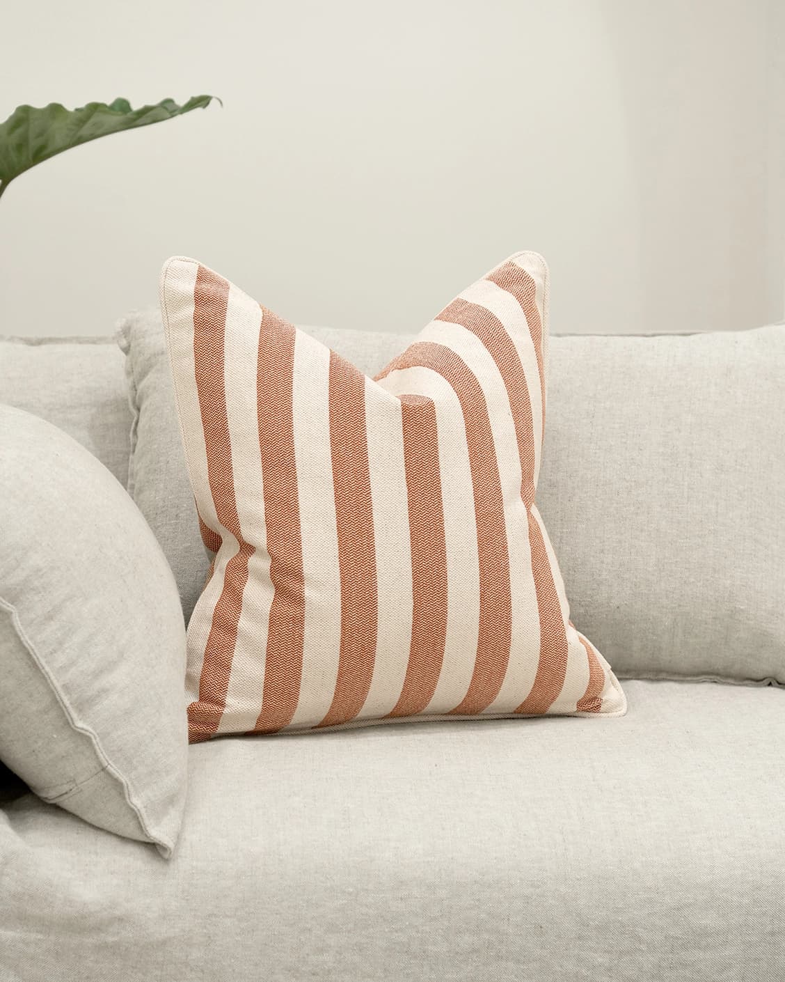 Ameline Rust cushion, shown in a lifestyle front view as image 2