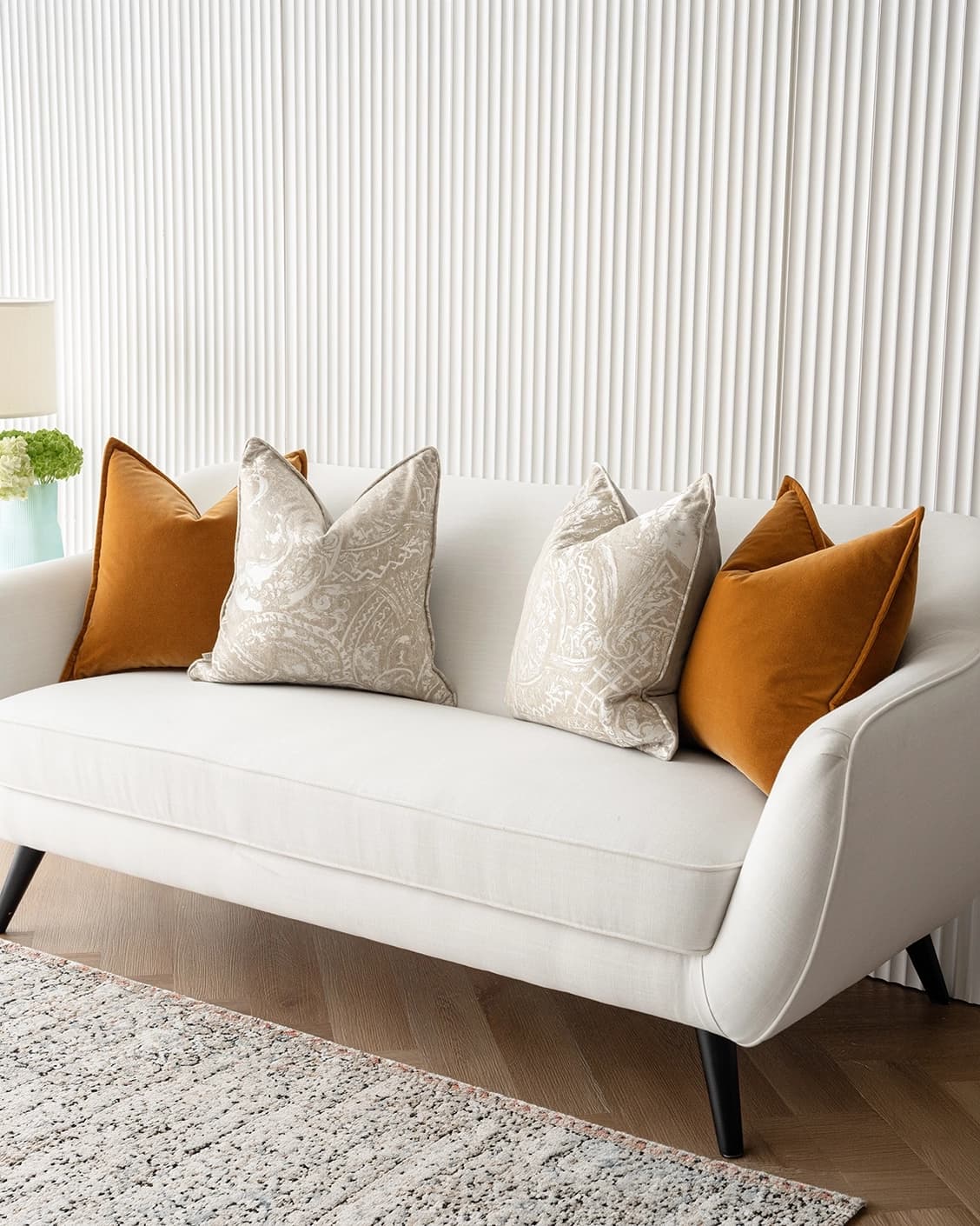 Amiya Bundle cushion in orange, beige and silver, shown in a lifestyle right view as image 2