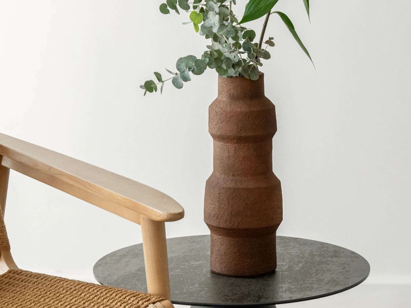 Anaya Arneson vases in rust and brown, shown in a lifestyle front view